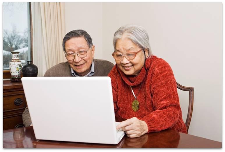 Senior couple looking at a laptop together
