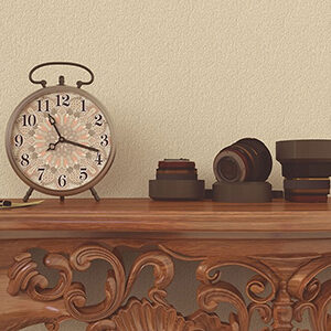 A clock and decor sitting on a shelf