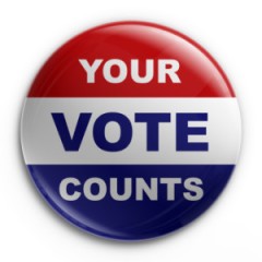 A pinback button that reads "Your Vote Counts" on a white background