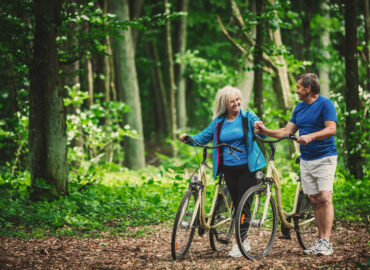 Couple bicycling in the woods