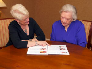 Ingrid consults with a client about a downsizing move