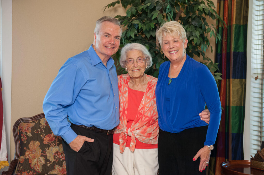 Ingrid and John Sullivan pose with a happy client